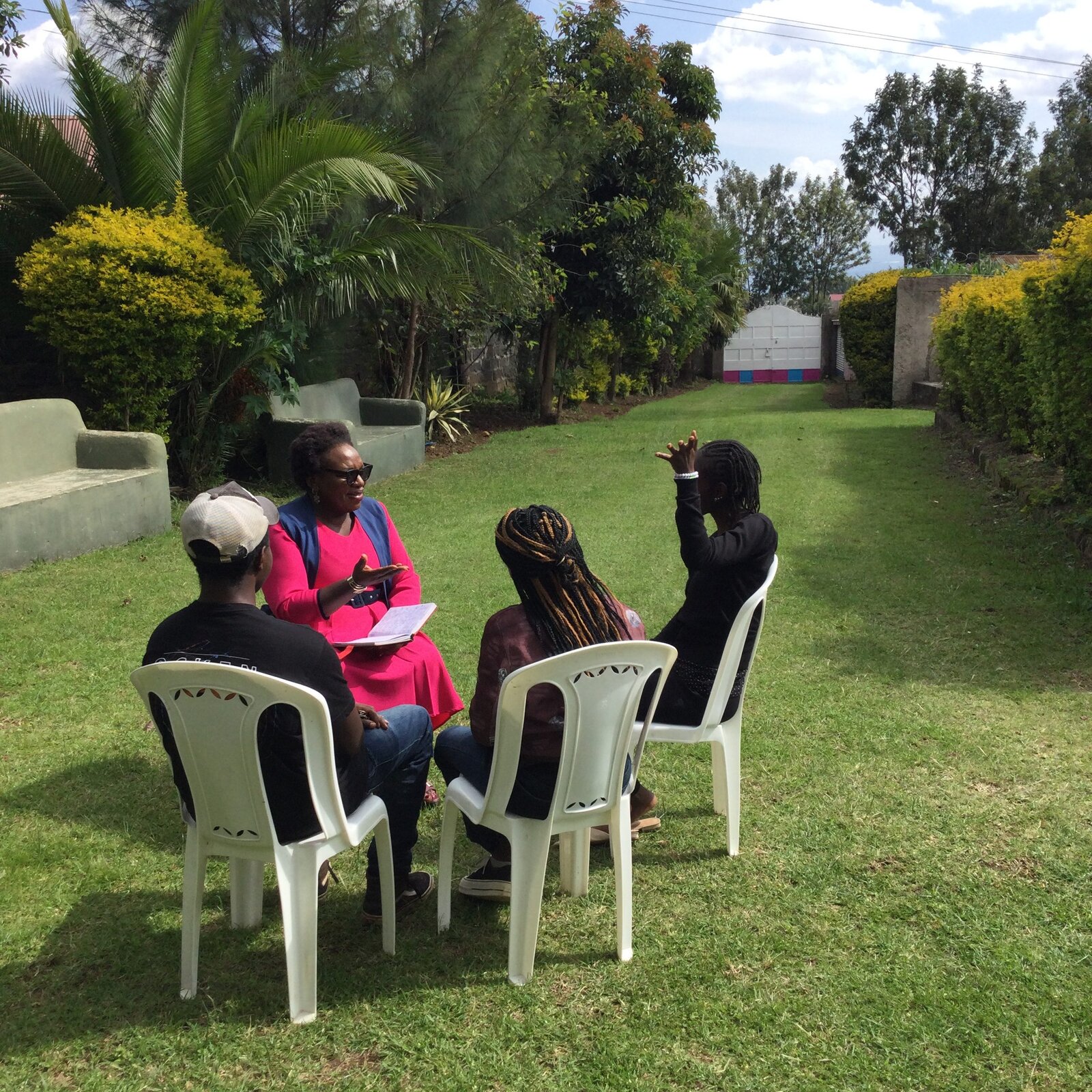 A Gapra Wellness Centre facilitator leading a group counseling session outdoors